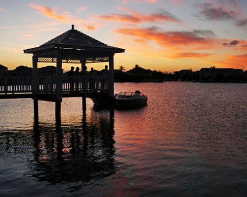 A wooden pier in the water at dusk.