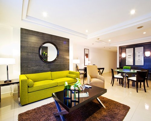 An open plan living and dining area with a pull out sofa.