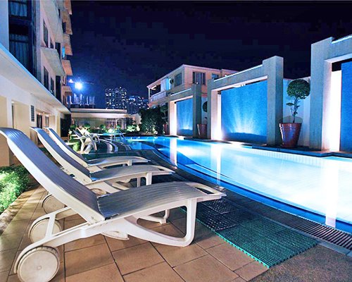 Outdoor swimming pool with chaise lounge chairs.