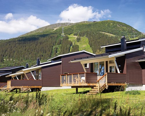 An exterior view of the resort units alongside the mountains.