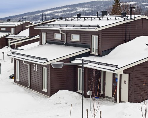 An exterior view of Holiday Club Are resort covered in snow.