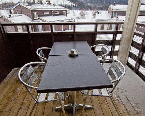 A balcony with a dining area.
