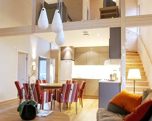An open plan living dining and kitchen area with a staircase.
