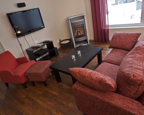 A well furnished living room with a television and fireplace.