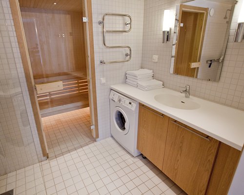 An open sink vanity alongside sauna.