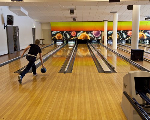 A man bowling at the bowling stadium.