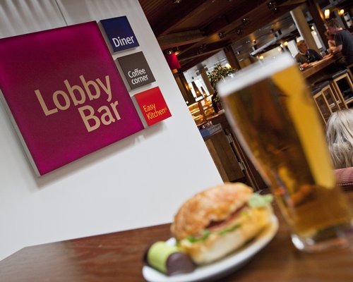 A food item and beverage at a bar counter.