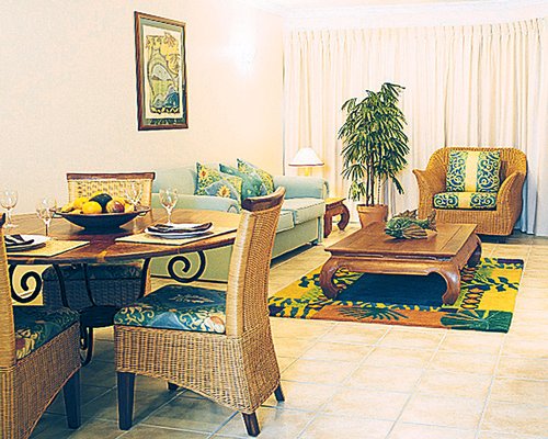 An open plan living and dining area with a pull out sofa.