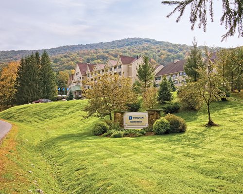 A scenic exterior view of Wyndham Bentley Brook resort with a signboard.