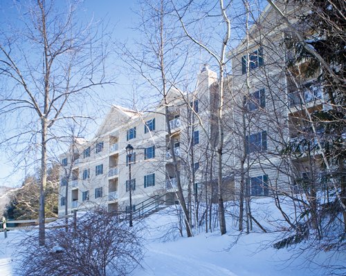 Exterior view of Wyndham Bentley Brook surrounded by the wooded area during winter.