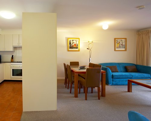 An open plan living and dining area alongside kitchen.