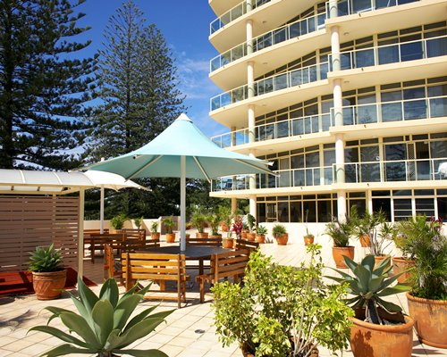 Exterior view of the resort with patio and sunshades.