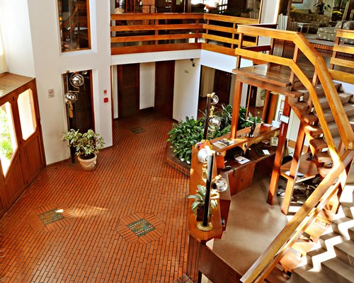 Balcony view of the reception area alongside a staircase.