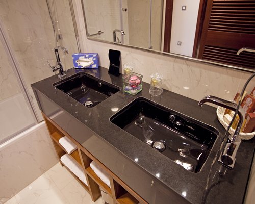 A bathroom with double open sink vanity.