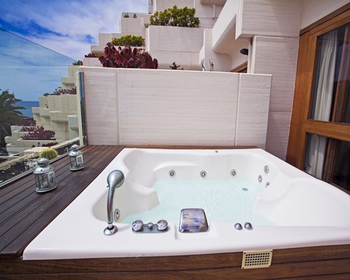 Outdoor hot tub on a balcony.