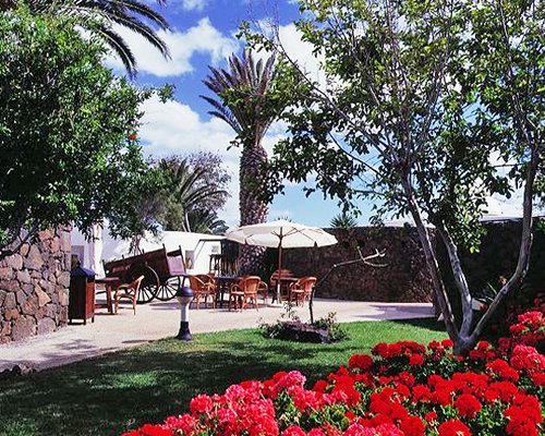 Pathway to an outdoor dining with sunshade.