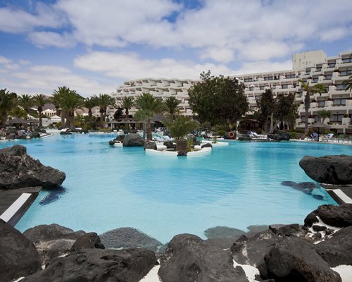 Club Melia at Gran Melia Salinas with large outdoor swimming pool surrounded by rocks and landscaping.