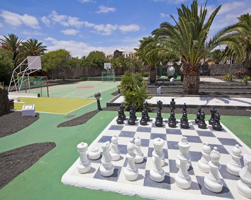 Outdoor recreation area with a giant chess and basketball court.