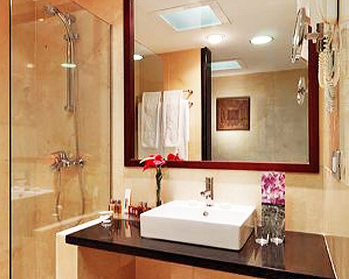 A bathroom with a shower stall and closed sink vanity.