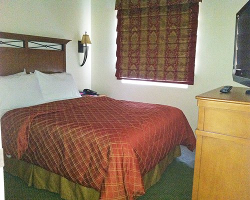 A well furnished bedroom with a television.