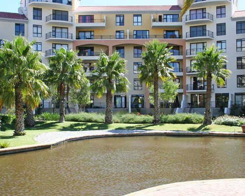 View of the waterfront with trees alongside multi story resort units.
