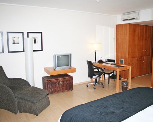 A well furnished bedroom with a television.
