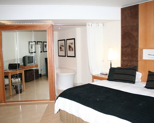 A well furnished bedroom with a television.