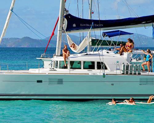 A group of people in a lagoon boat on the ocean.