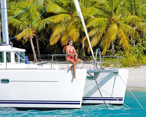 A view of women in the sailboat on the beach.