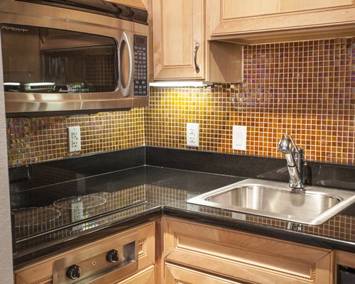 A well equipped kitchen with a microwave oven.