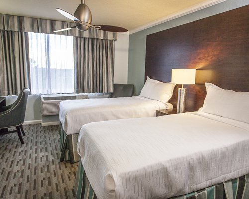 A well furnished bedroom with two beds.