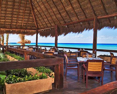 An outdoor fine dining restaurant alongside the sea.