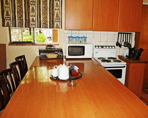 An open plan kitchen with breakfast bar and outside view.