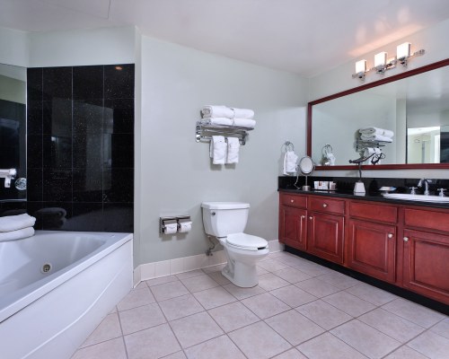 A BATHROOM WITH SHOWER BATHTUB AND CLOSED SINK VANITY.