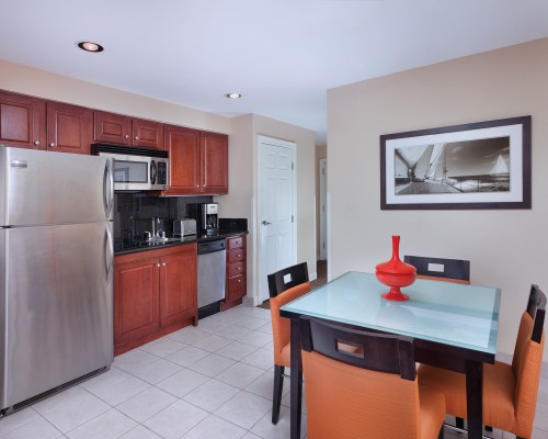 AN OPEN PLAN DINING AND KITCHEN AREA WITH A MICROWAVE OVEN.