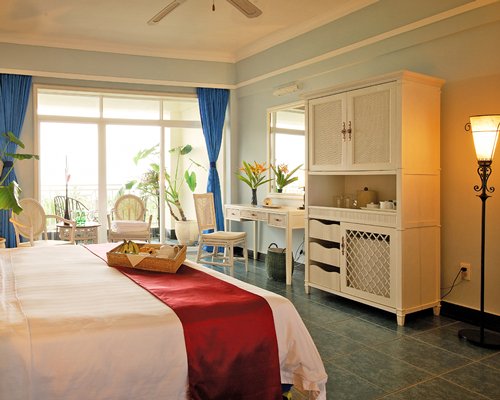 A well furnished bedroom and balcony.