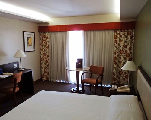 A well furnished bedroom with patio furniture.