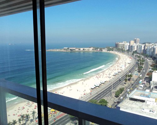 Balcony view of the ocean and beach.