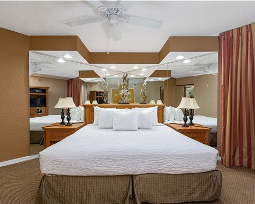 A well furnished bedroom with two twin beds and bathroom.