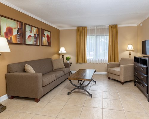 A well furnished living room with dining area and open plan kitchen.