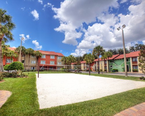 Exterior view of Legacy Vacation Club Orlando Resort World with outdoor tennis court.