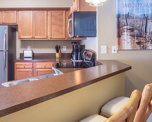A well equipped kitchen with breakfast bar.