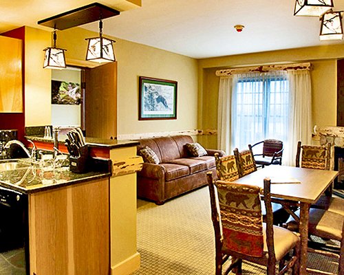 An open plan living room with a sofa dining and kitchen area.