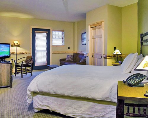 A well furnished bedroom with a television.