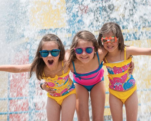 A group of kids enjoying in the water shower.