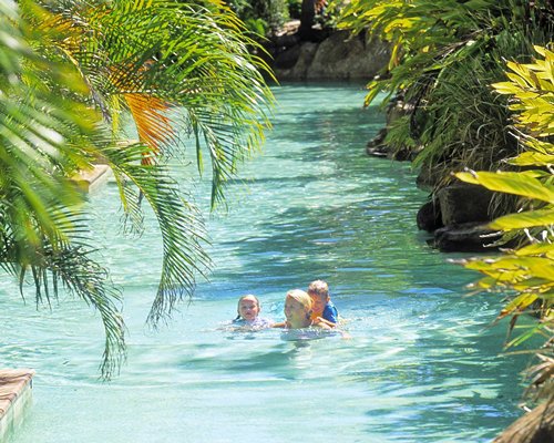 A group of people enjoying in a swimming pool.
