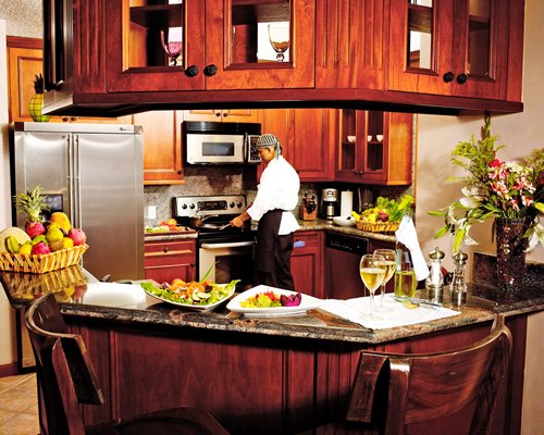 A well equipped kitchen with breakfast bar and microwave.