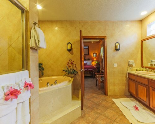 A bathroom with bathtub and single sink vanity.