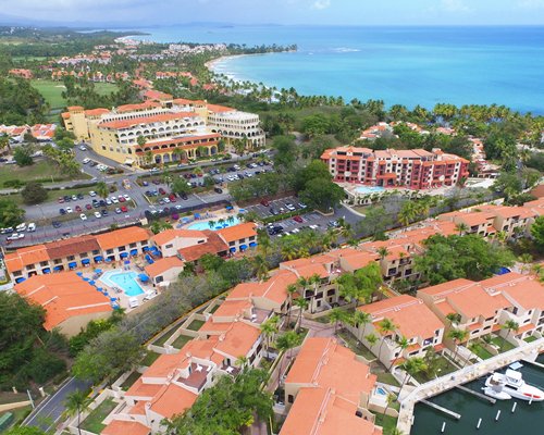 An exterior view of Royal Holiday Park Royal Club Cala resort with trees.
