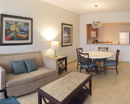 A well furnished living and dining area alongside a kitchen.